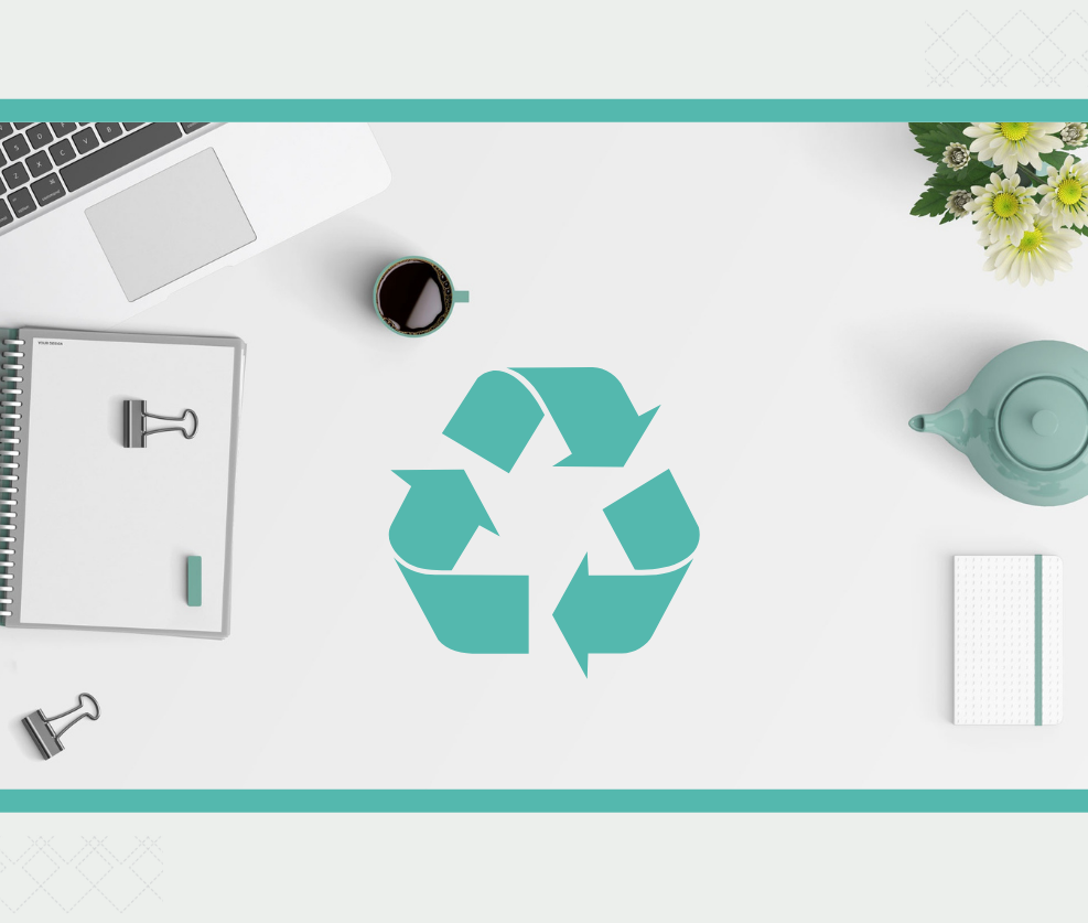 Desk spread with a recycle sign